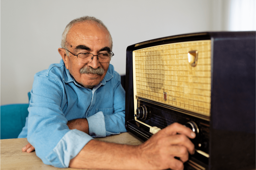 An Elderly Man Turning Up the Radio